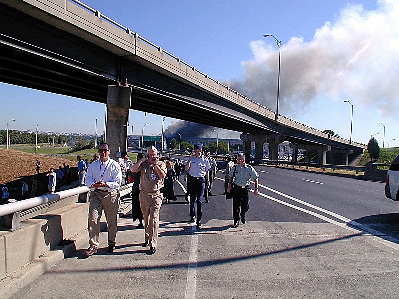 Military and civilian personnel walking down Interstate 395 after evacuating the Pentagon on September 11, 2001